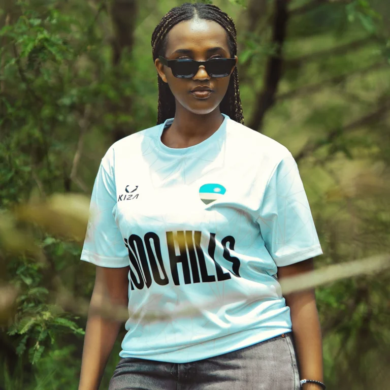 Woman wearing 1000 HILLS WHITE LINE KIZA football jersey in Kigali