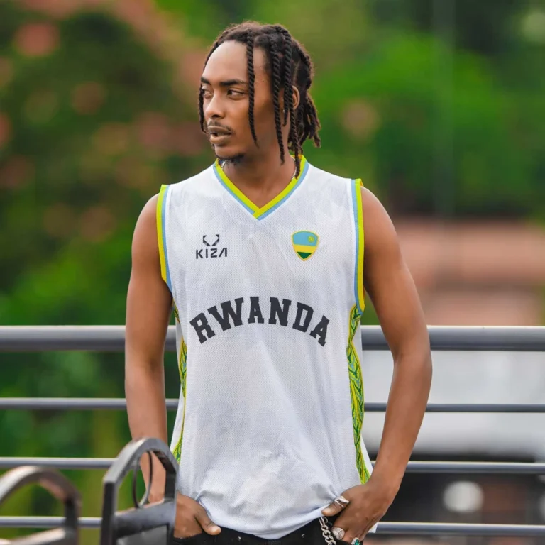 Man wearing KIZA white basketball jersey with national colors and bold RWANDA lettering