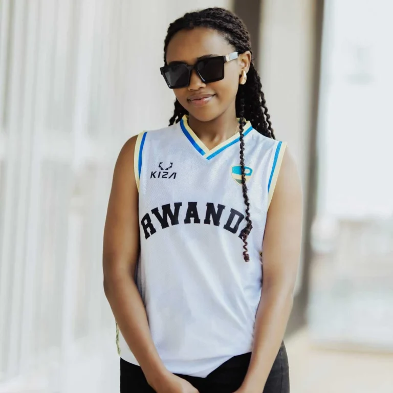 Woman wearing RWANDA WHITE KIZA jersey with Inyambo detail and embroidered flag badge